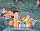 Boy relaxing in the pool with a floating ring