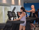 Man and woman using a treadmill in the gym