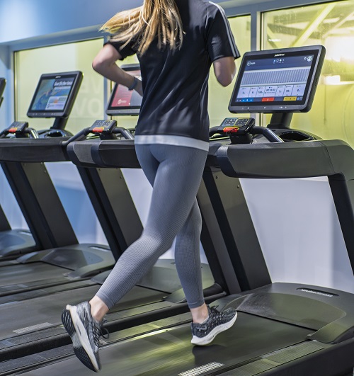 woman running on a treadmill wearing correct gym gear